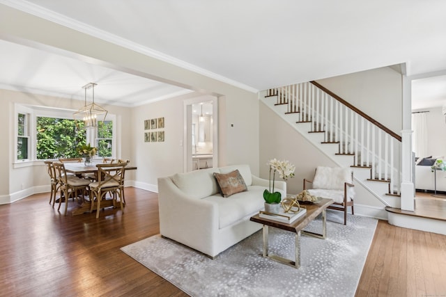 living room with baseboards, crown molding, stairway, and hardwood / wood-style floors