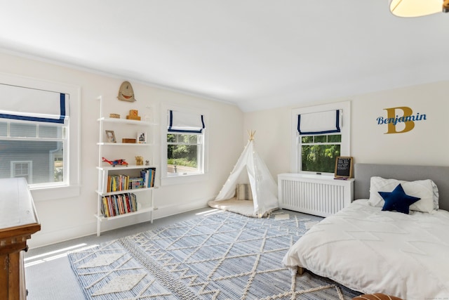 carpeted bedroom with baseboards and radiator