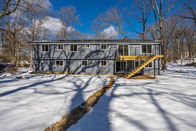 view of front of house featuring stairs and a wooden deck