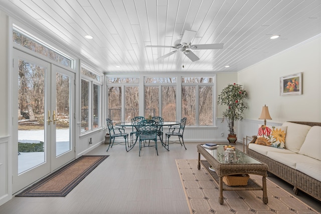 sunroom featuring a healthy amount of sunlight, wood ceiling, and french doors