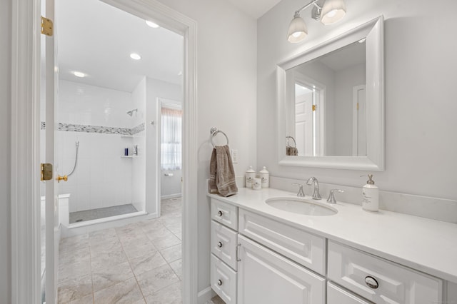 bathroom with a stall shower and vanity