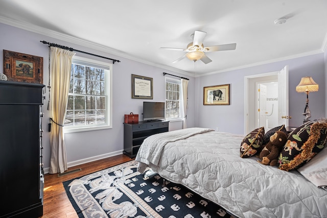 bedroom with ornamental molding, baseboards, and wood finished floors