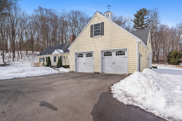 view of front of property featuring a garage and a shingled roof