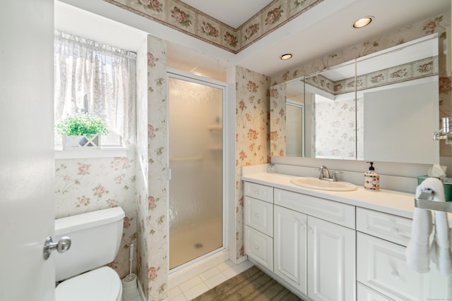 full bath featuring wallpapered walls, a stall shower, vanity, toilet, and tile patterned flooring