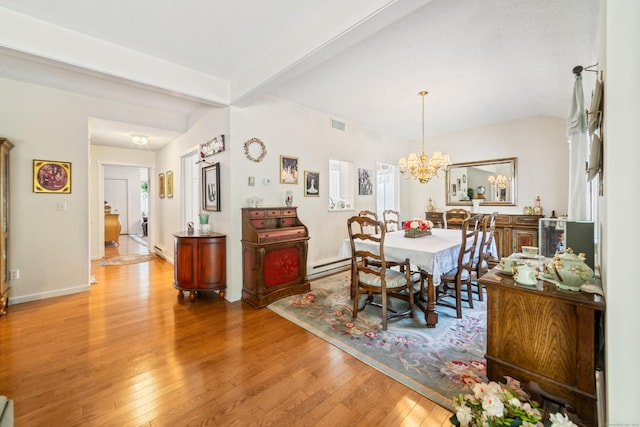 dining space featuring visible vents, baseboards, a chandelier, wood finished floors, and a baseboard radiator