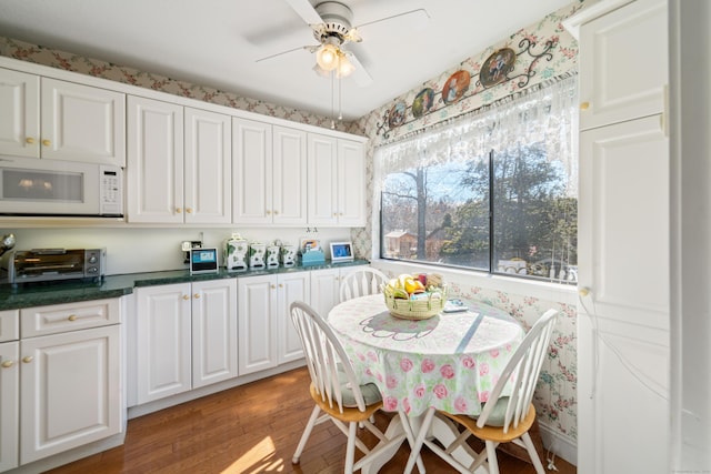 dining space featuring light wood-style flooring, a toaster, and ceiling fan