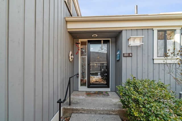 doorway to property featuring board and batten siding