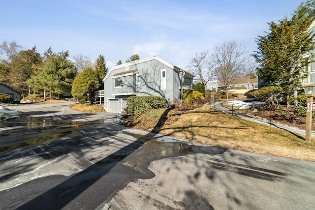 view of home's exterior with driveway and a garage