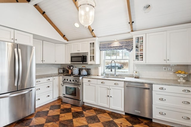 kitchen with tasteful backsplash, lofted ceiling with beams, glass insert cabinets, stainless steel appliances, and white cabinetry