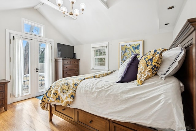 bedroom featuring access to outside, multiple windows, vaulted ceiling, and light wood-style flooring