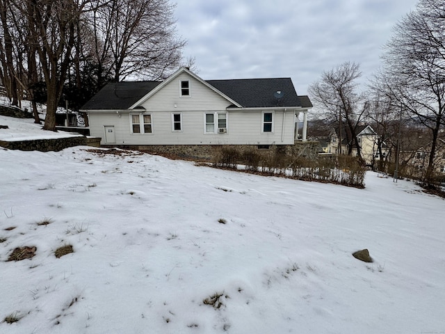 snow covered house with a garage