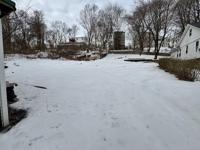 yard covered in snow featuring a garage