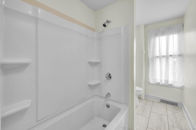 bathroom featuring shower / washtub combination, baseboards, visible vents, and toilet