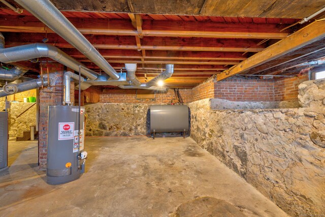 unfinished basement with heating fuel and water heater