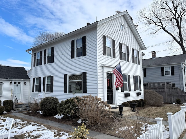 view of front of home featuring fence