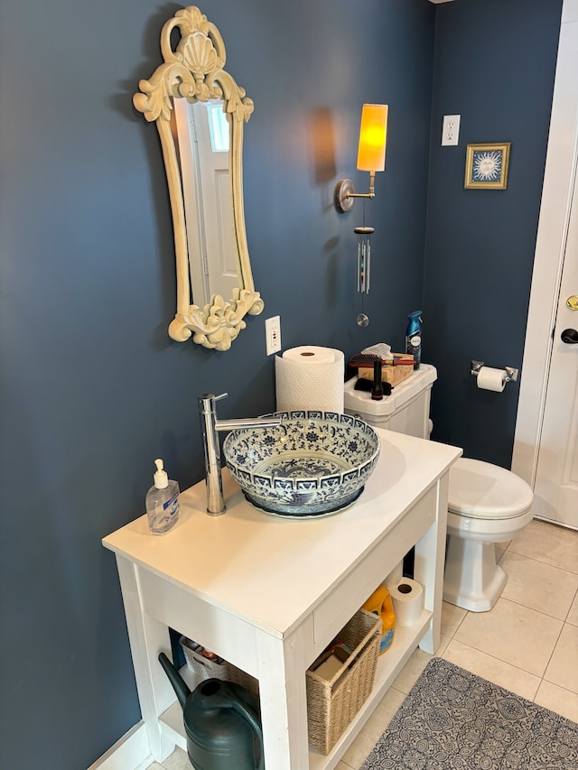 bathroom with vanity, toilet, and tile patterned floors