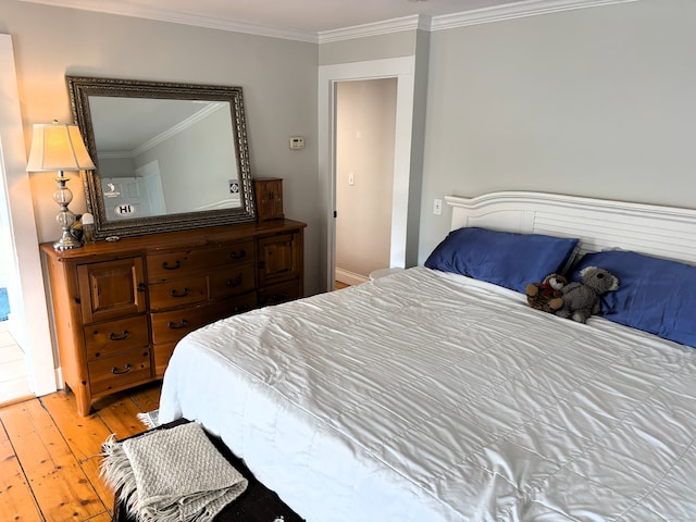 bedroom featuring ornamental molding and hardwood / wood-style floors