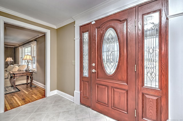 entryway featuring light tile patterned floors, baseboards, and ornamental molding