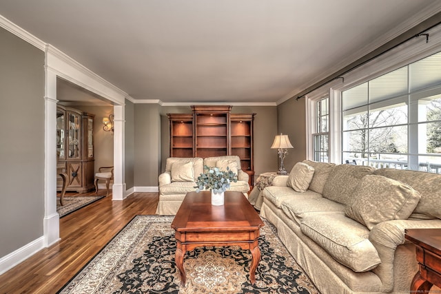 living area with crown molding, wood finished floors, and baseboards