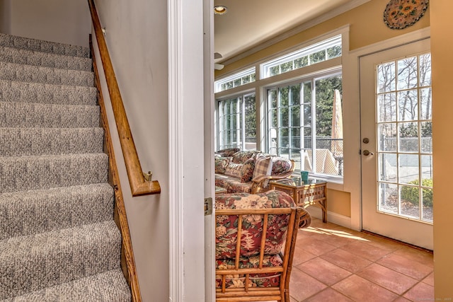 staircase with tile patterned floors and a healthy amount of sunlight