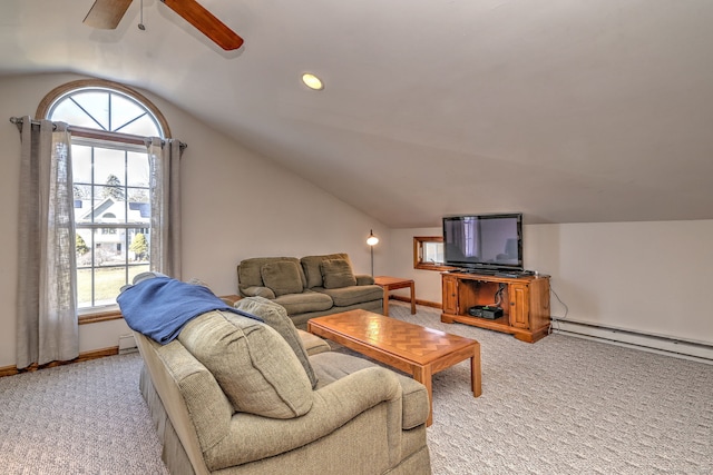 living area with vaulted ceiling, light colored carpet, a wealth of natural light, and a baseboard radiator