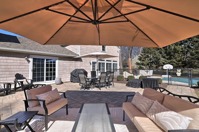 view of patio / terrace with a gate, fence, an outdoor living space, outdoor dining area, and a grill