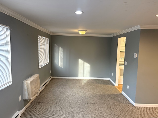 carpeted spare room with a baseboard radiator, crown molding, and baseboards