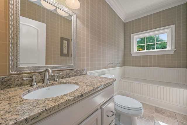 bathroom with toilet, tile patterned floors, crown molding, and vanity