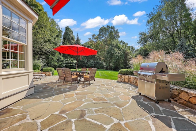 view of patio featuring outdoor dining space and a grill