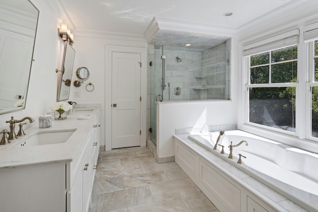 full bathroom featuring a stall shower, a garden tub, and a sink