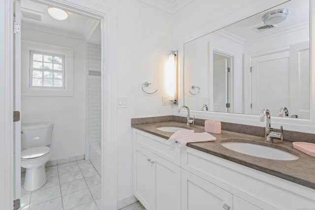 full bathroom with double vanity, toilet, ornamental molding, and a sink
