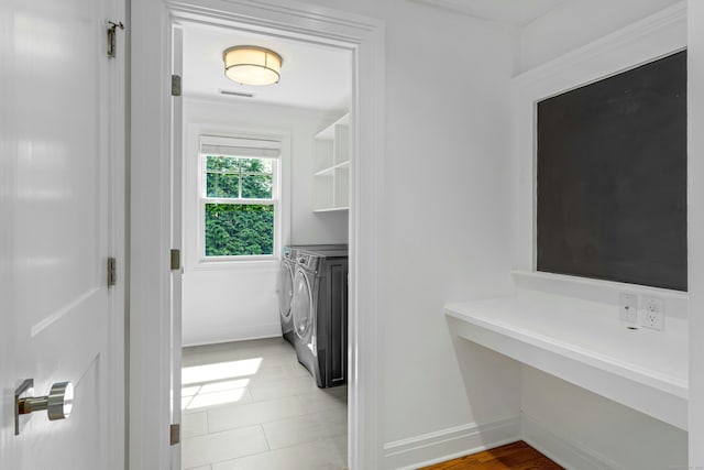 interior space featuring washer and clothes dryer, laundry area, baseboards, and visible vents