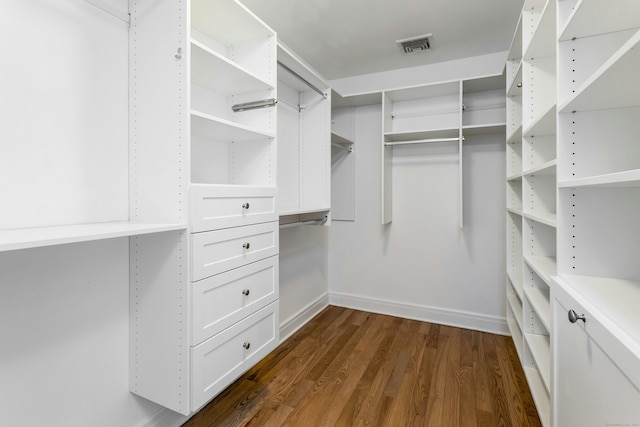 walk in closet with dark wood-style floors and visible vents