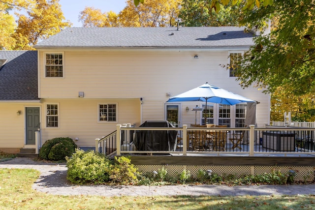 back of property featuring entry steps, roof with shingles, and a wooden deck