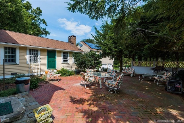 view of patio featuring entry steps, outdoor dining area, and fence