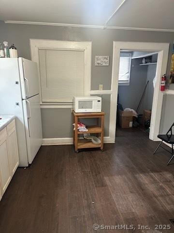 interior space featuring dark wood-style floors and ornamental molding