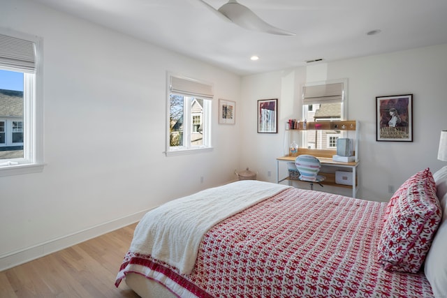 bedroom with baseboards, visible vents, a ceiling fan, wood finished floors, and recessed lighting