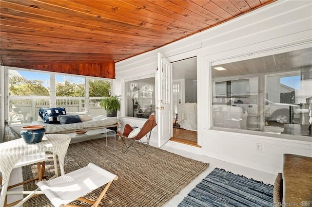 sunroom / solarium featuring wood ceiling and vaulted ceiling