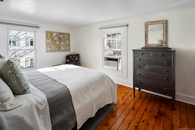 bedroom with baseboards and hardwood / wood-style floors