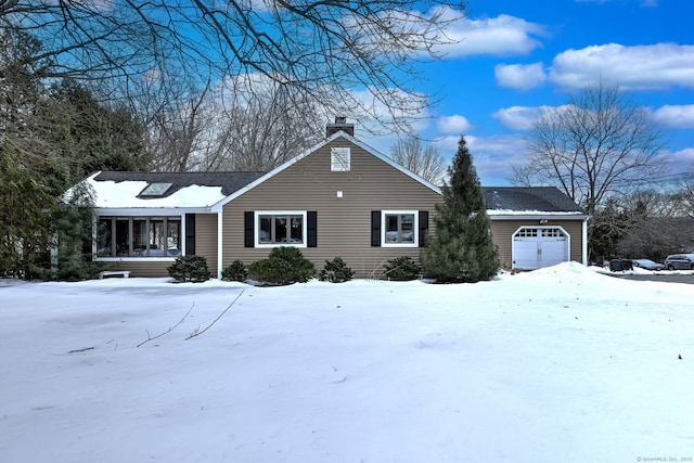 ranch-style house featuring covered porch, a chimney, and an attached garage