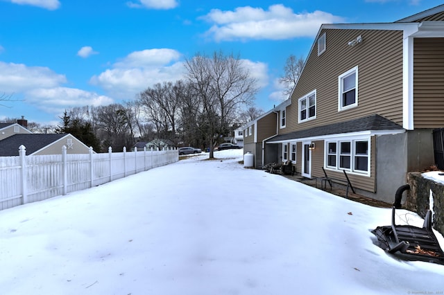 yard layered in snow with fence