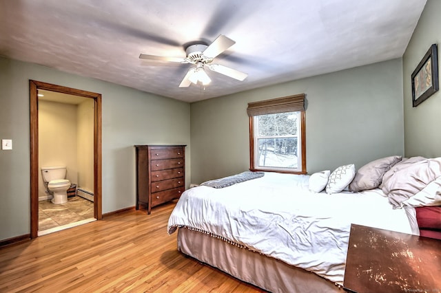 bedroom featuring baseboards, connected bathroom, ceiling fan, baseboard heating, and light wood-type flooring