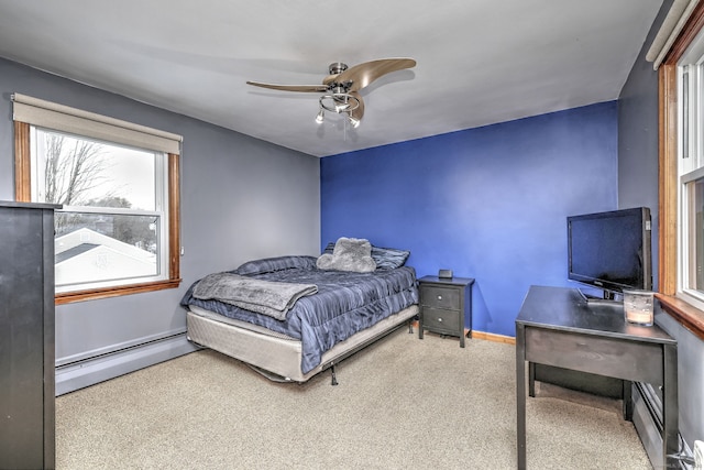 bedroom with a ceiling fan, baseboards, baseboard heating, and carpet flooring