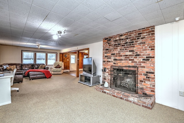 carpeted living room with a fireplace