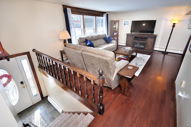 living room featuring a baseboard radiator, a baseboard heating unit, stairway, baseboard heating, and dark wood finished floors