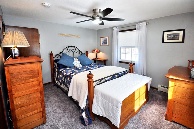 bedroom featuring baseboards, dark carpet, baseboard heating, and a ceiling fan