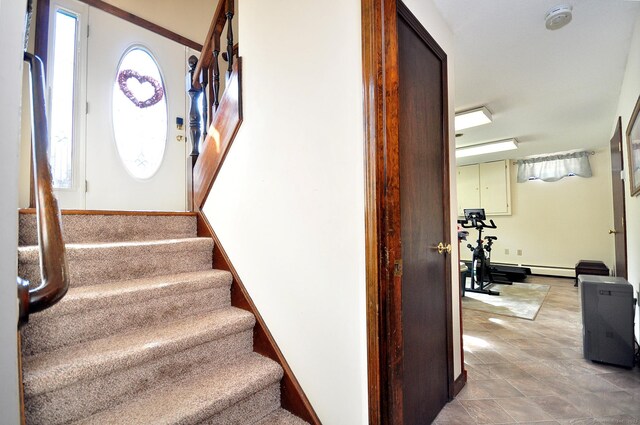 staircase with baseboards and a wealth of natural light