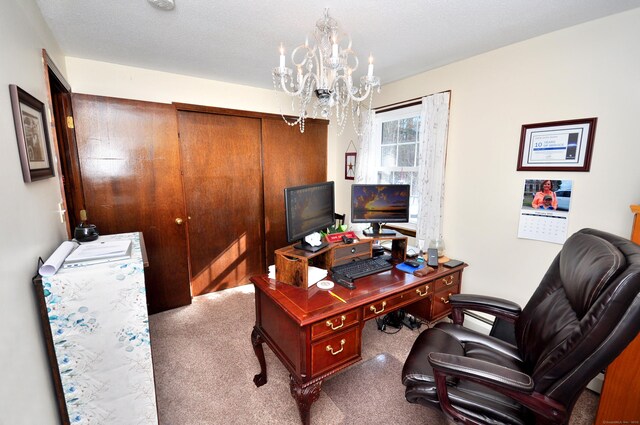 home office featuring carpet flooring and a notable chandelier