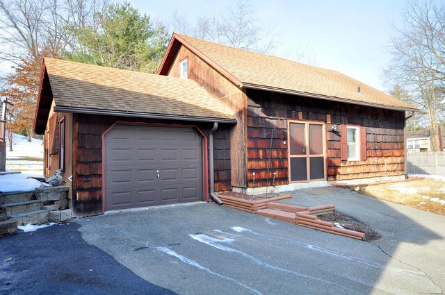 garage featuring aphalt driveway