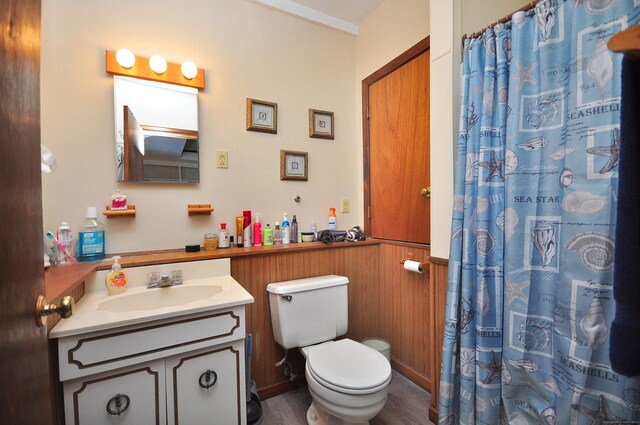 full bath with toilet, curtained shower, wood finished floors, and vanity